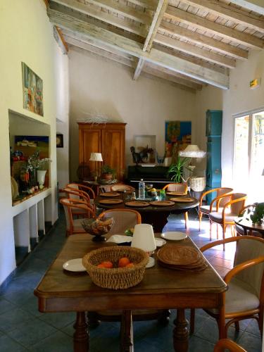 a living room with wooden tables and chairs at La Ferme de Thoudiere in Saint-Étienne-de-Saint-Geoirs