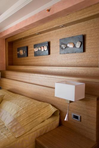 a bedroom with a headboard with skulls on the wall at Monte Casa SPA & Wellness in Petrovac na Moru