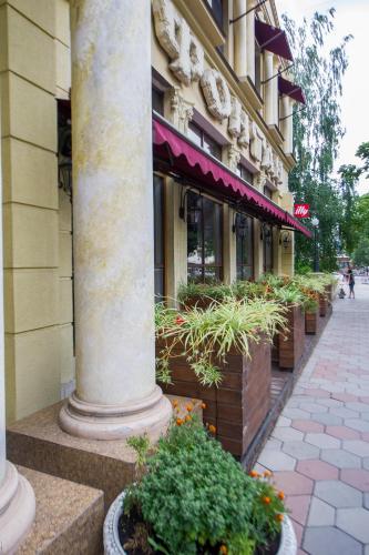 a building with a column and plants in front of it at Fontan in Chornomorsk