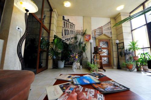 a living room with plants and a table in a building at Fontan in Chornomorsk