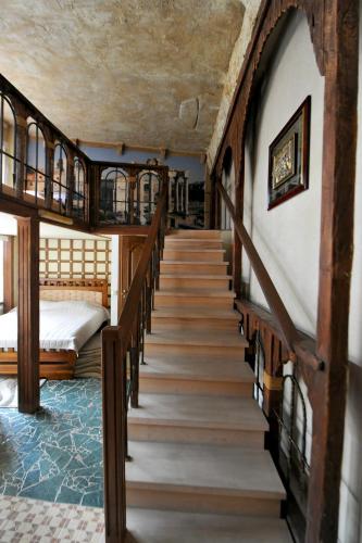 a staircase leading up to a bedroom with a bed and a bed sqor at Fontan in Chornomorsk