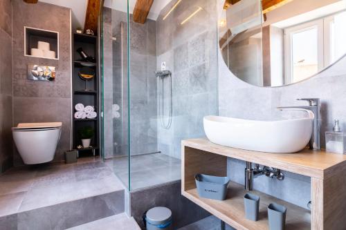 a bathroom with a sink and a shower at Luxury Apartment Sea View in Split