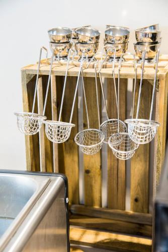 a group of measuring cups and utensils on a table at Ibis Styles Sallanches Pays du Mont-Blanc in Sallanches