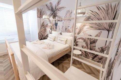 a bedroom with a bunk bed with plants on the wall at Duna Hotel Boutique in Peñíscola
