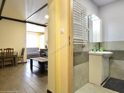 a bathroom with a sink and a mirror at Apartamenty u Bodzia in Stronie Śląskie