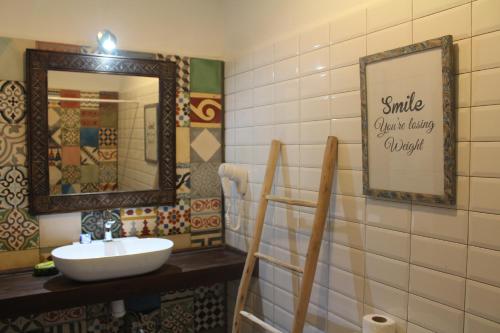 a bathroom with a sink and a mirror at Riad Inna & Watersports Center in Essaouira