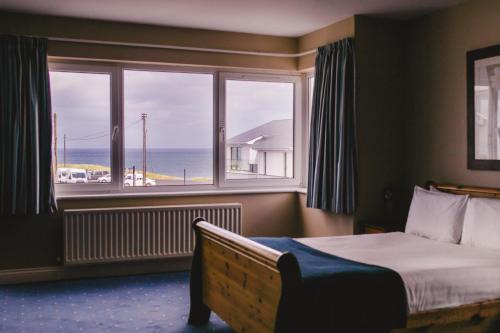 A bed or beds in a room at Inn On The Coast