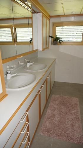a bathroom with two sinks and a mirror at Haus Edeltraud in Mellau
