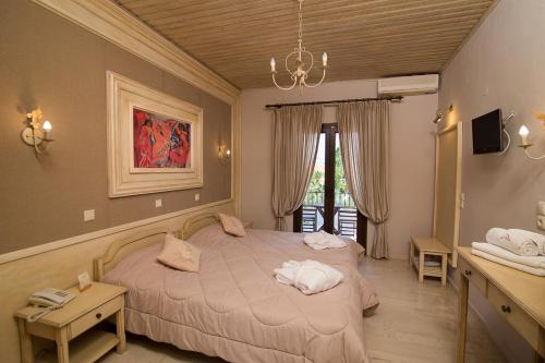 a bedroom with a bed with towels on it at Akti Hotel & Apartments in Mythimna