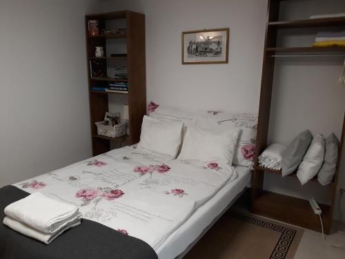 a bedroom with a bed with pink flowers on it at Studio in Krakow