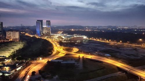 an aerial view of a city at night with lights at IOI Golf Suite in Putrajaya