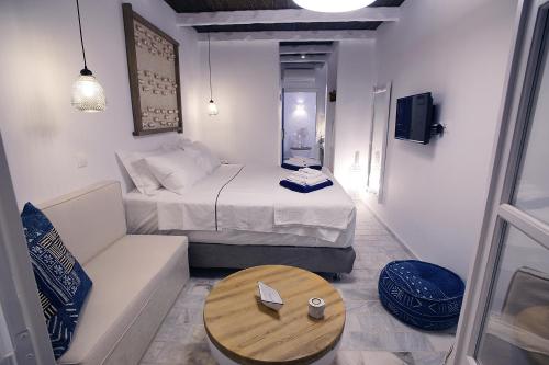 a small room with a bed and a coffee table at La Playa Boutique Apartments in Kalymnos