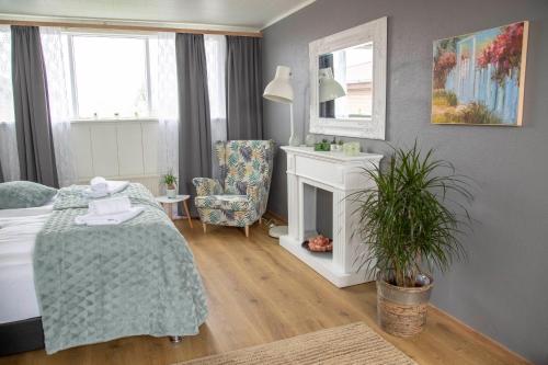 a bedroom with a bed and a fireplace and a chair at Private and peaceful one bedroom apartments in Borgarnes