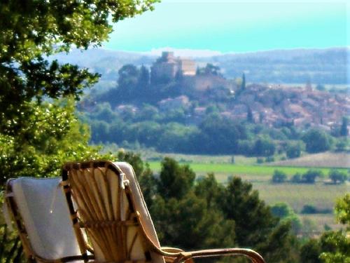 a chair sitting on top of a hill with a view at Le Mas Sérénité in Ansouis