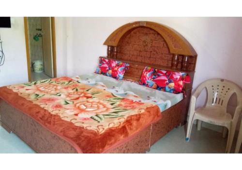 a bedroom with a large bed with a wooden headboard at Peaceful Palace in Pushkar in Pushkar