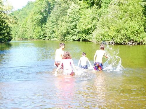 a group of people in the water in a river at gite du navech in Camjac