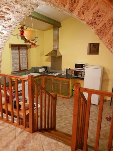 a kitchen with a counter and a stove top oven at Gite Du Tourdre in La Cresse