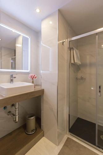a bathroom with a sink and a shower at Ático Centro Málaga in Málaga