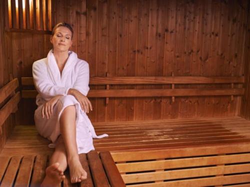 a woman is sitting in a sauna at Gran Hotel Toloma in Cochabamba