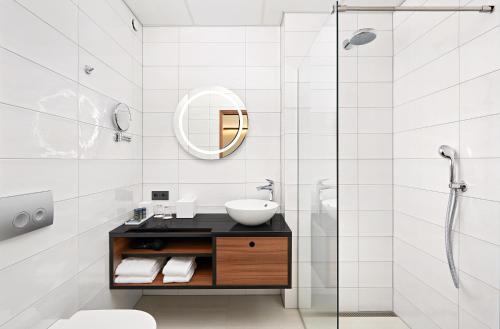 a bathroom with a sink and a mirror at Hotel Örk in Hveragerði