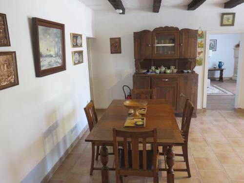 a dining room with a wooden table and chairs at Lemoniegites in Lemonie