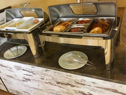 a buffet with some food and a plate of food at Complex Bolyarsko selo & Spa Arbanasi in Arbanasi