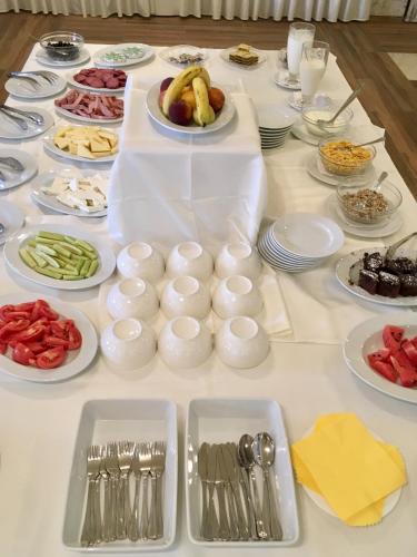 a table with plates of food on a table at Complex Bolyarsko selo & Spa Arbanasi in Arbanasi
