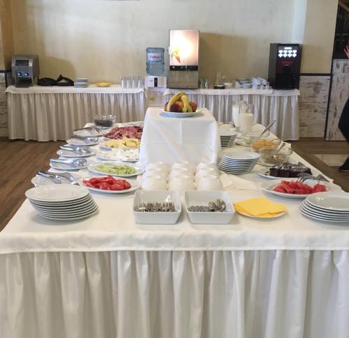 a white table with plates of food on it at Complex Bolyarsko selo & Spa Arbanasi in Arbanasi