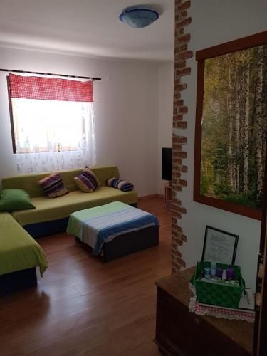 a living room with a couch and a window at Holiday Home Poljičko Imanje in Donji Dolac