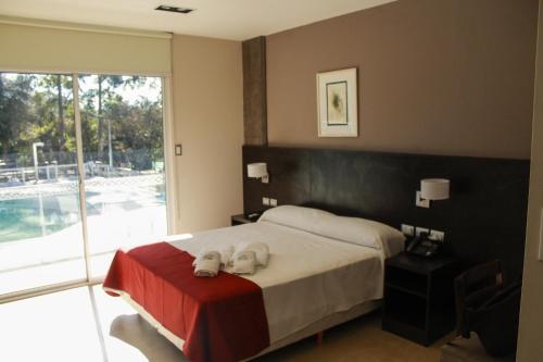 a bedroom with a bed with two dogs on it at Hostería Atahualpa Yupanqui in Tafí Viejo