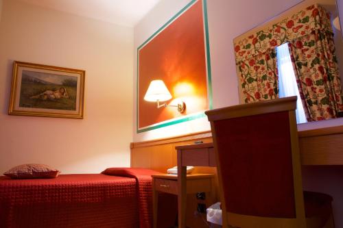 a hotel room with a bed and a window at Hotel La Luna in Lucca