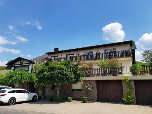 a house with a white car parked in front of it at Weingut Erich Serwazi in Mesenich