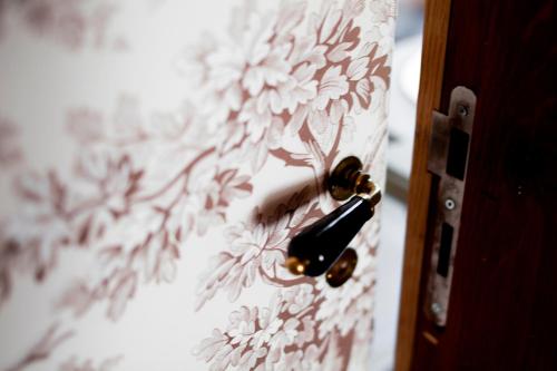 a door knob with a flower pattern on a curtain at Château De Riell in Molitg les Bains