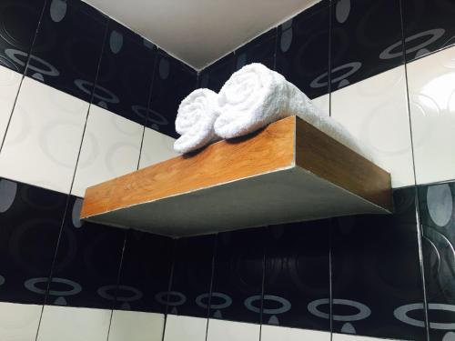 a statue of a cloud on a shelf in a bathroom at Italy Condotel Darasa in Tanauan