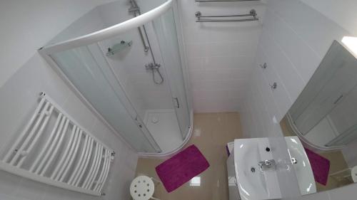 a white bathroom with a sink and a toilet at Apartamenty Kozienice in Kozienice