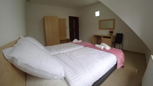 a bedroom with a bed with white sheets and pillows at Apartamenty Kozienice in Kozienice