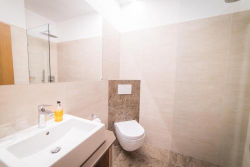 a bathroom with a white sink and a toilet at Pension Apartments Pardell in Castelbello-ciardes