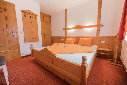 a bedroom with a large wooden bed in a room at Ferienheim Gasteig in Neustift im Stubaital
