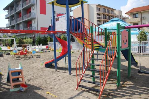 a playground with a slide in the sand at Sangria Luxury Family in Mamaia Nord