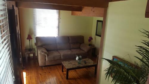 a living room with a couch and a table at Courtney's Place Historic Cottages & Inns in Key West