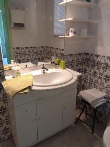 a bathroom with a sink and a mirror at les alicantes in Coursan