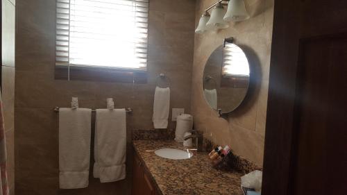 a bathroom with a sink and a mirror at Courtney's Place Historic Cottages & Inns in Key West