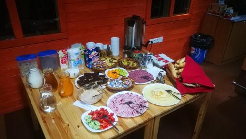 a table topped with plates of food and drinks at Penzion U Horejšů, Zadov - Churáňov in Stachy