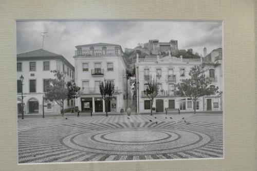 a black and white photo of a courtyard with buildings at Guest House Eça - Centro Histórico Leiria in Leiria