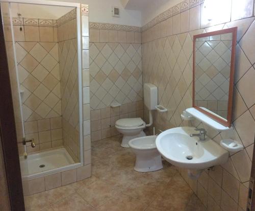 a bathroom with a toilet and a sink and a shower at Il veliero blu camere sul porto in Lampedusa