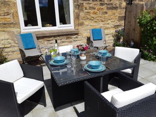 a table and chairs on a patio at Lizzies Cottage in Berwick-Upon-Tweed