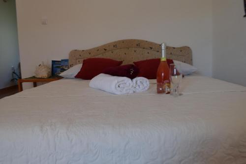 a bed with towels and wine bottles on it at Bisha Apartments in Ulcinj