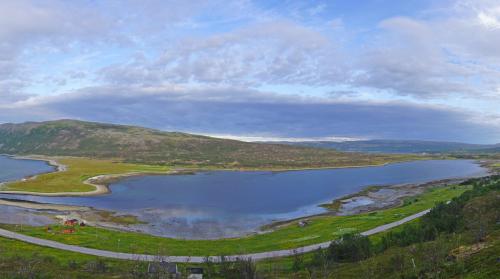 an aerial view of a lake in the hills at Rivdnji Holiday Home Smørfjord in Russenes