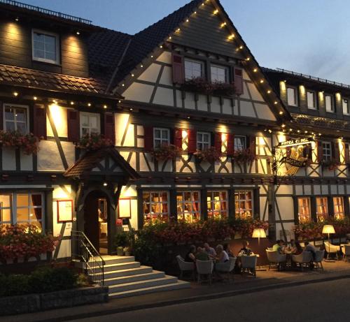 a building with people sitting outside of it at Hotel Restaurant Der Engel, Sasbachwalden in Sasbachwalden