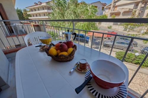 a basket of fruit on a table on a balcony at Casa Maja in Badolato